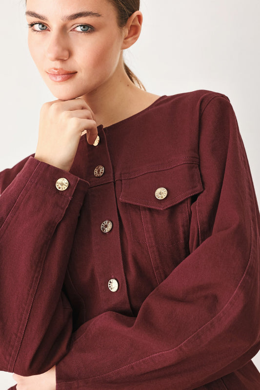 Model wearing the burgundy woven jacket with the matching burgundy skort.