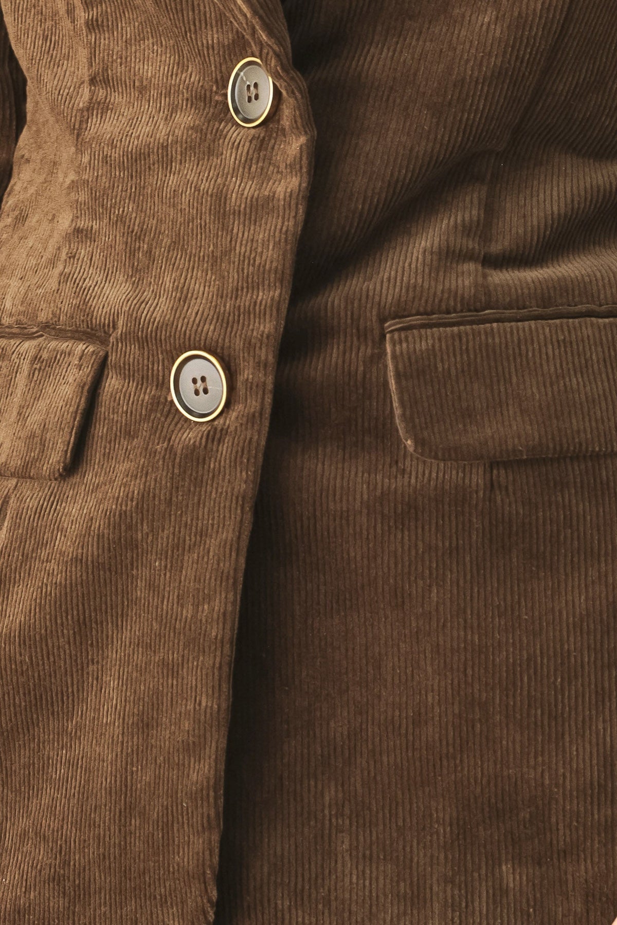 Close-up of a brown corduroy jacket or coat showing the buttoned front, a chest pocket, and the ribbed fabric texture.