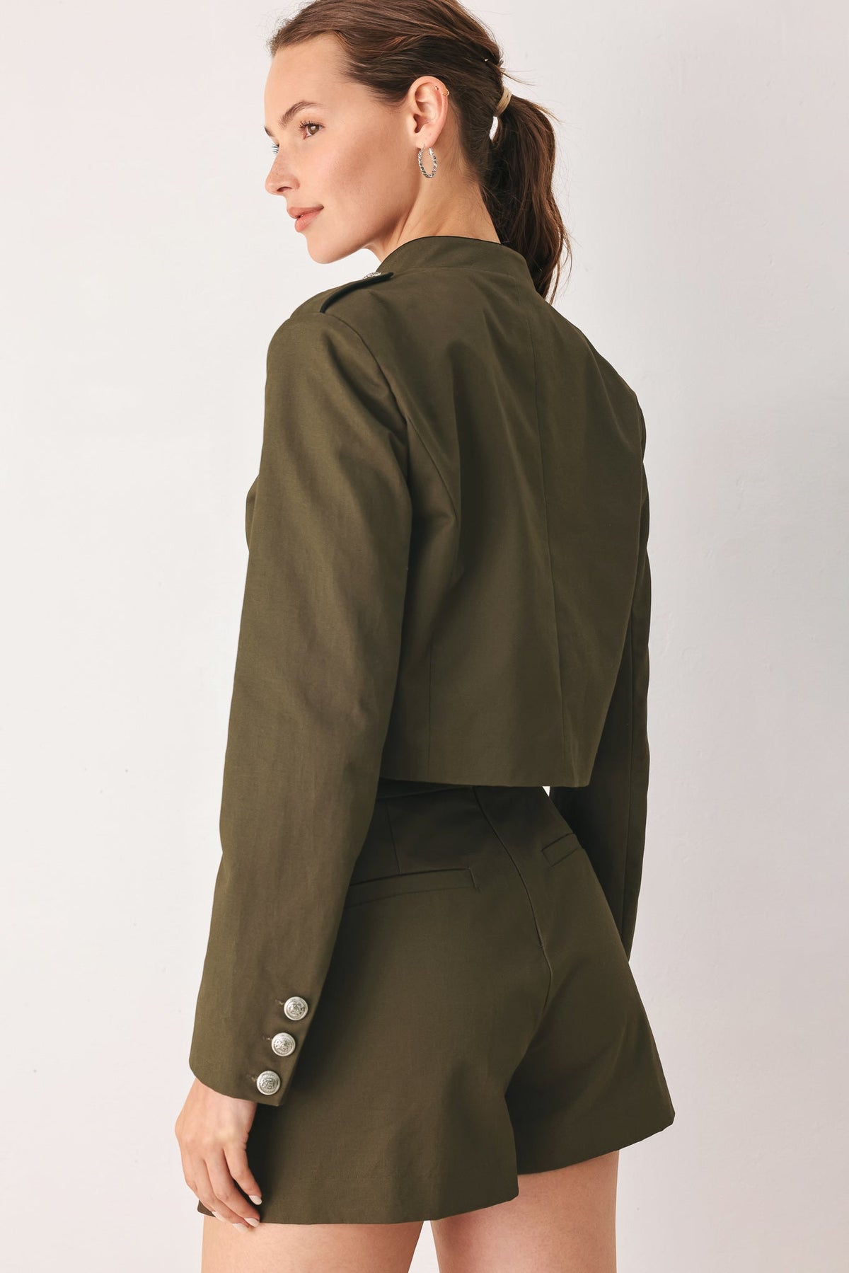 Olive cotton crop jacket styled with the matching Ranger Green tailored skort.