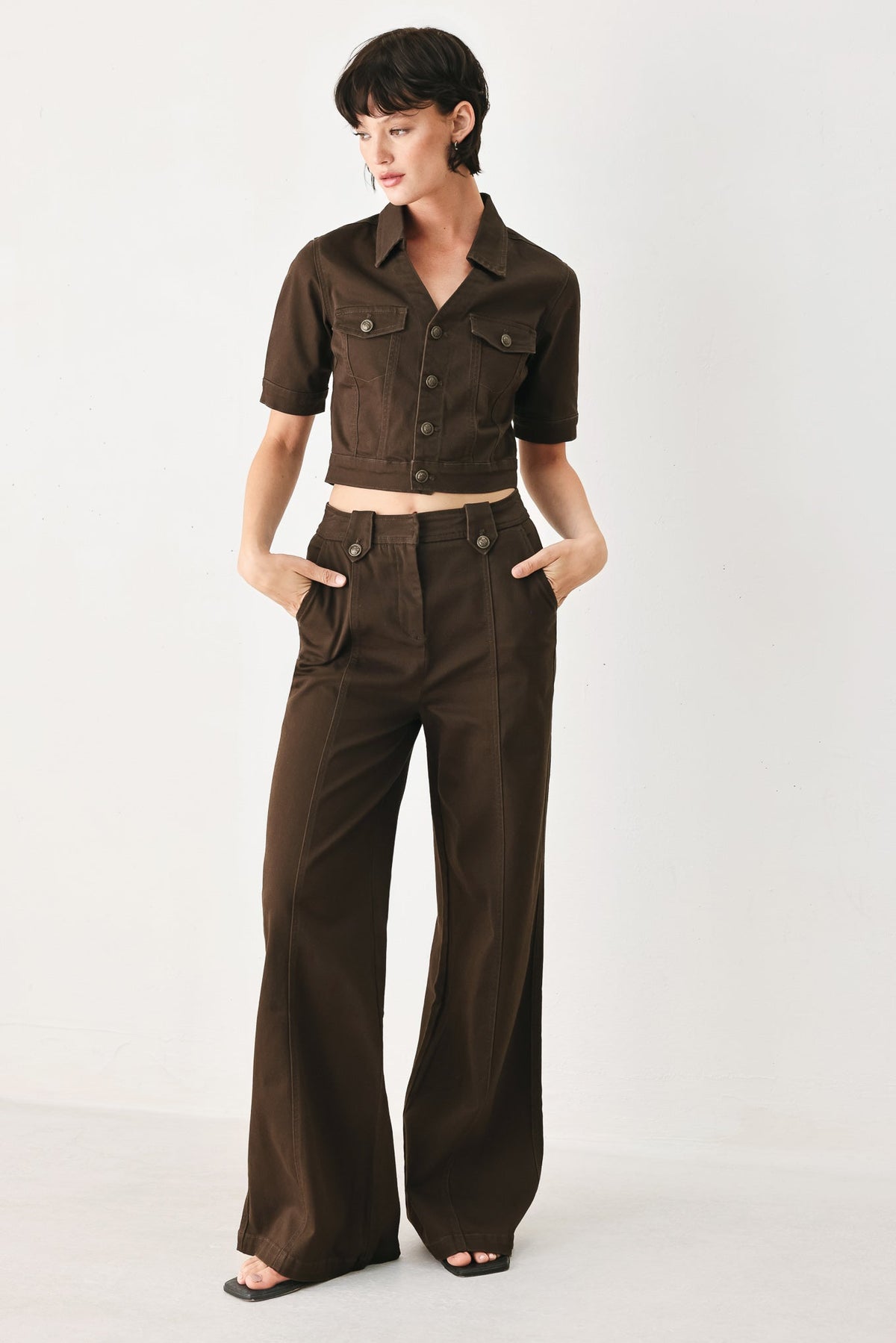 Model wearing the brown wide-leg pants with the matching cropped brown jacket.