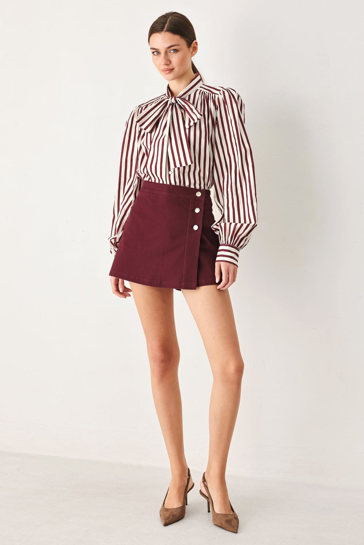 Front view of the burgundy woven skort showing the mini-skirt front over built-in shorts.