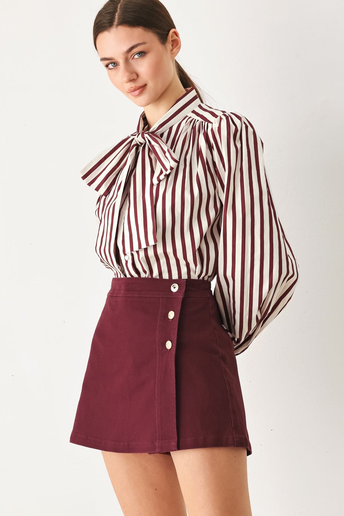 Burgundy cotton skort worn on a model in a light studio setting.