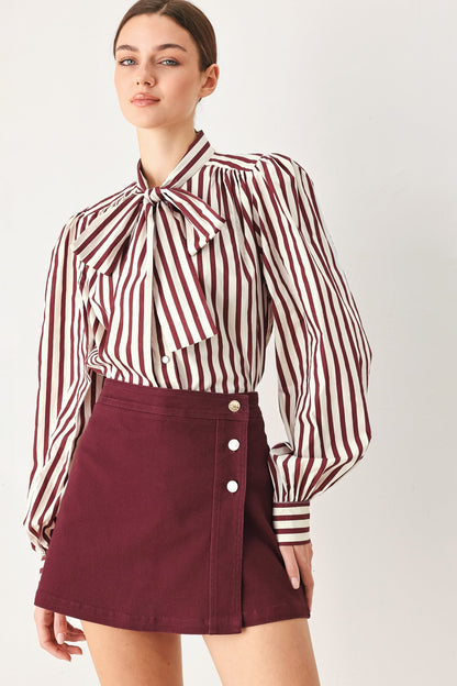 Back view of the burgundy woven skort on a model against a plain background.