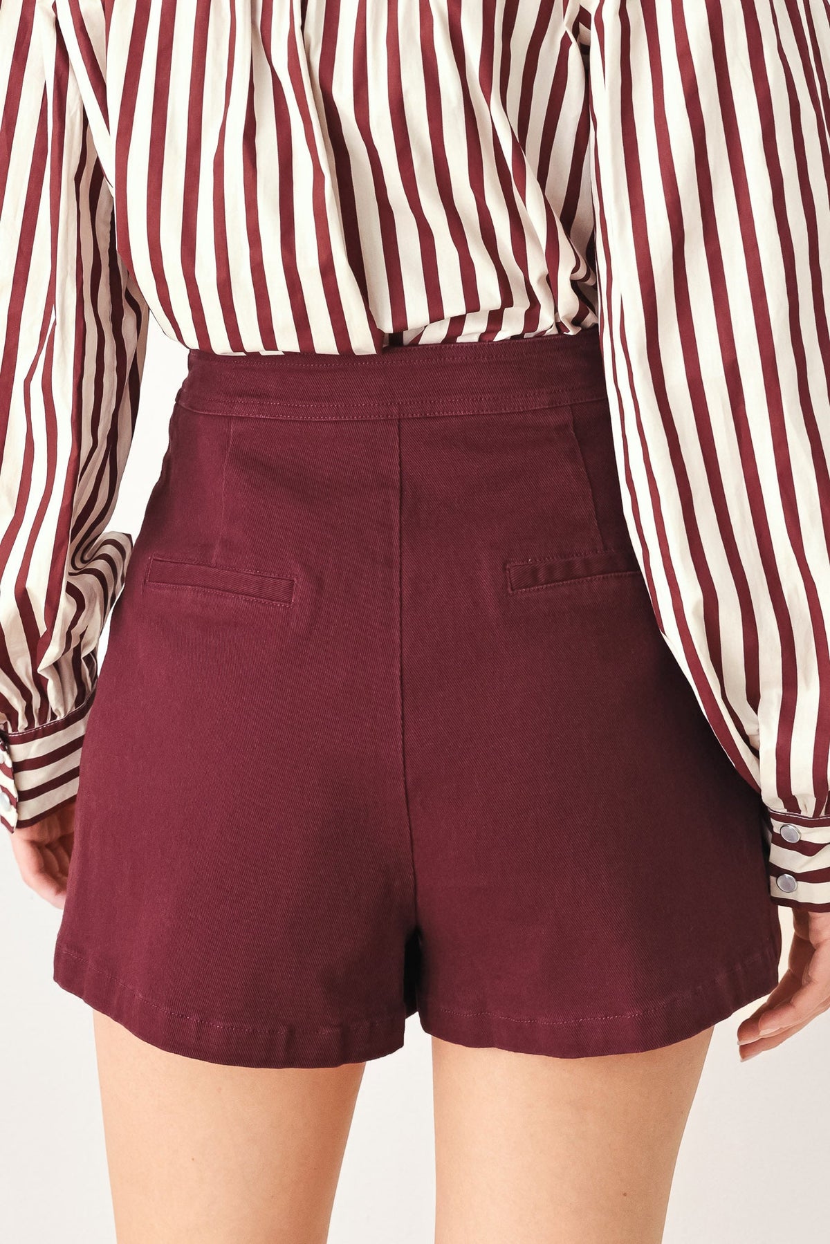 Model wearing the burgundy woven skort with the matching burgundy jacket.