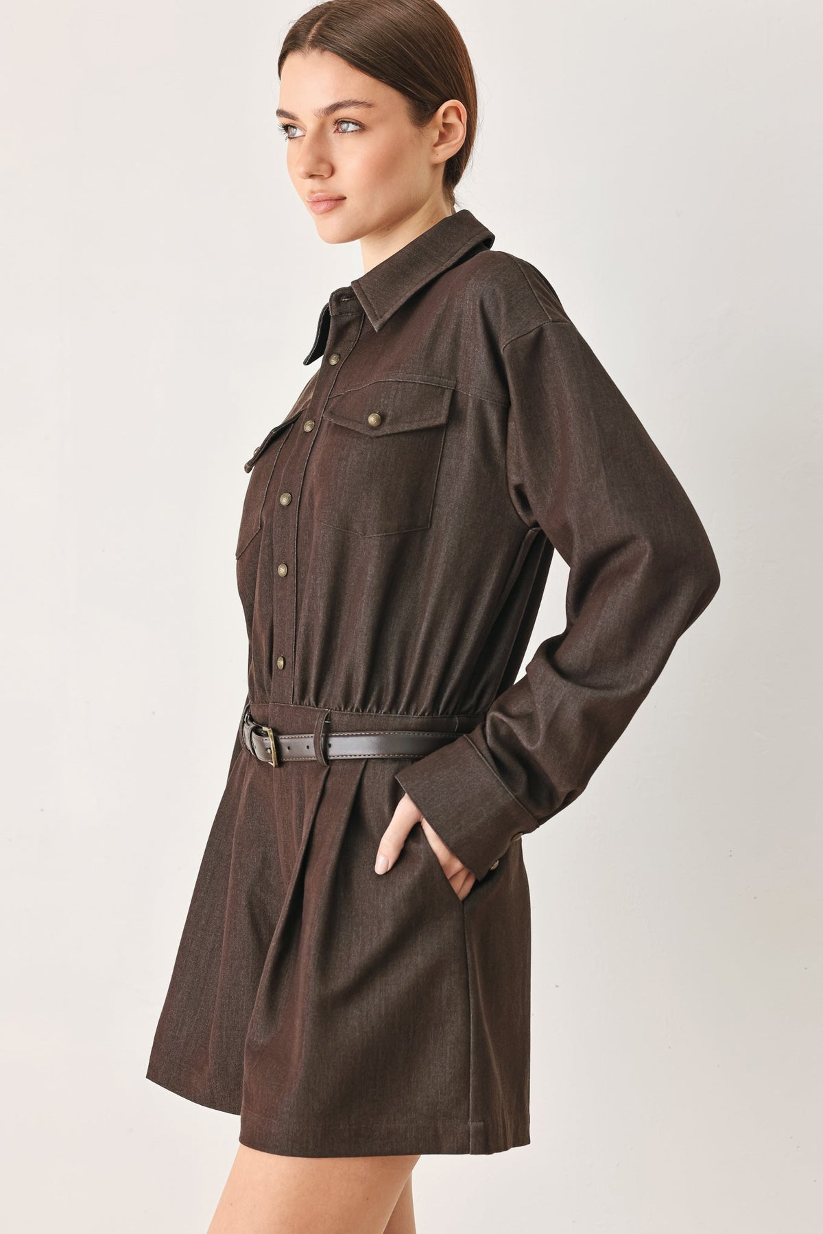 Utility-inspired woven romper in brown at an approximate 32 inch length.