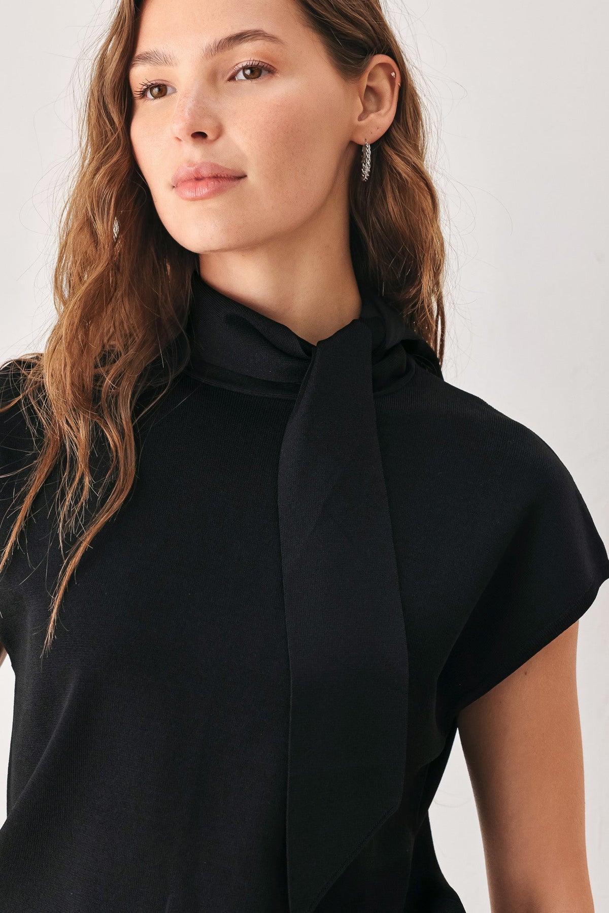 Short cap sleeves on a soft viscose-nylon sweater knit top.