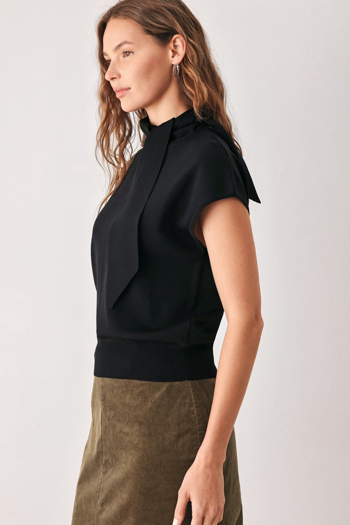 Soft knit top with a scarf-style neckline tie and a polished silhouette.