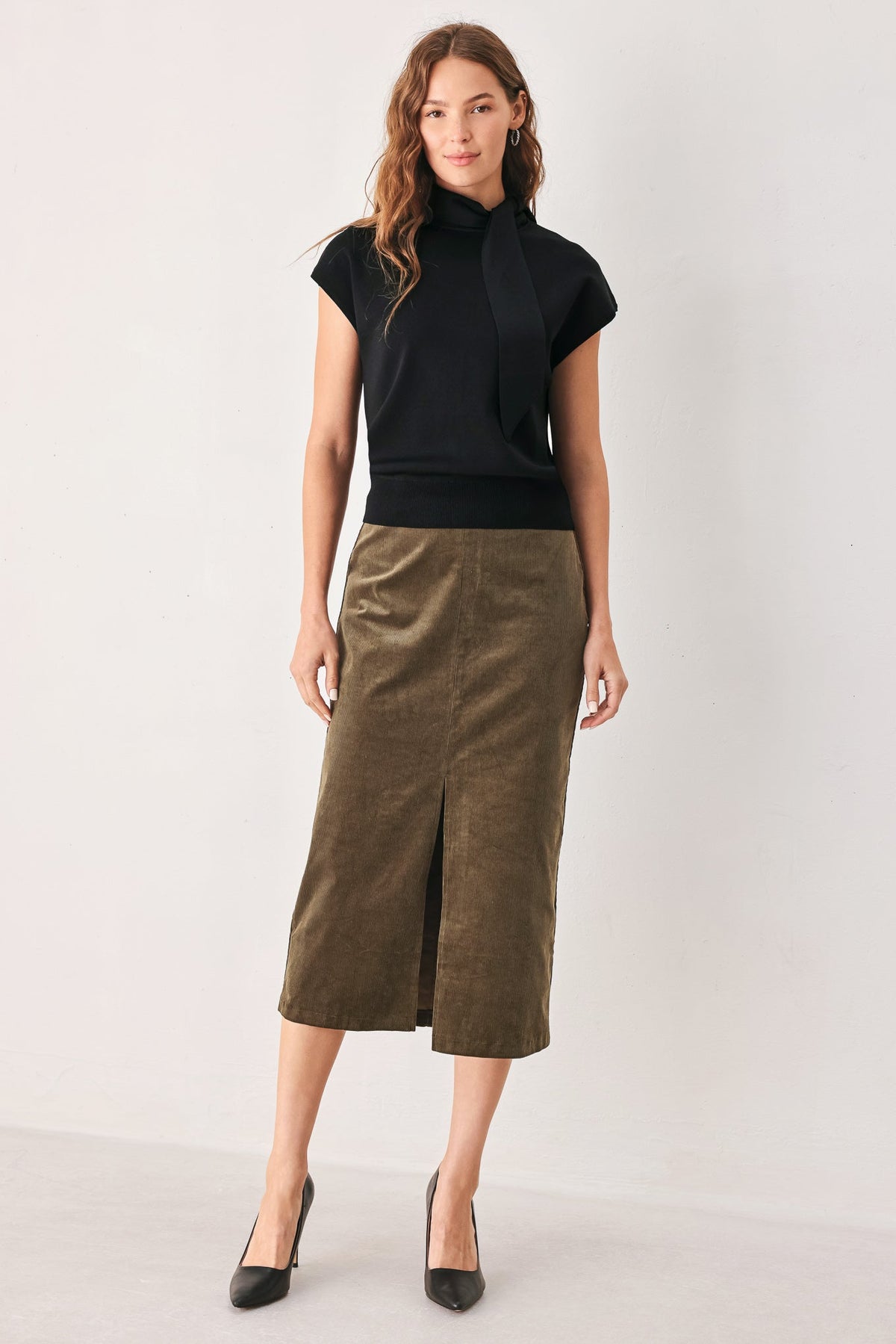 Sweater knit top at an approximate 22 inch length, worn untucked.