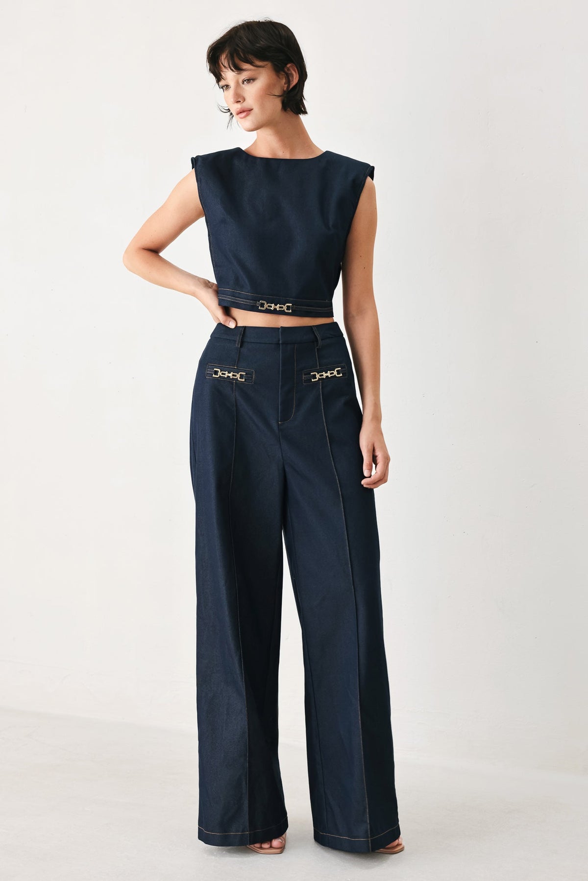 Indigo woven crop top with a hardware accent as a polished focal point.