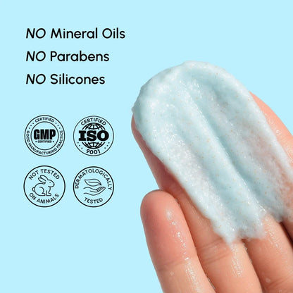 Hand holding a smear of cream with certification logos on a light blue background
