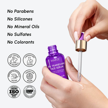 Purple face serum bottle with dropper held by hands, against a white background with certification logos.