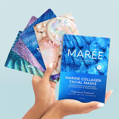 Hand holding a package of Maree marine collagen facial masks against a light blue background