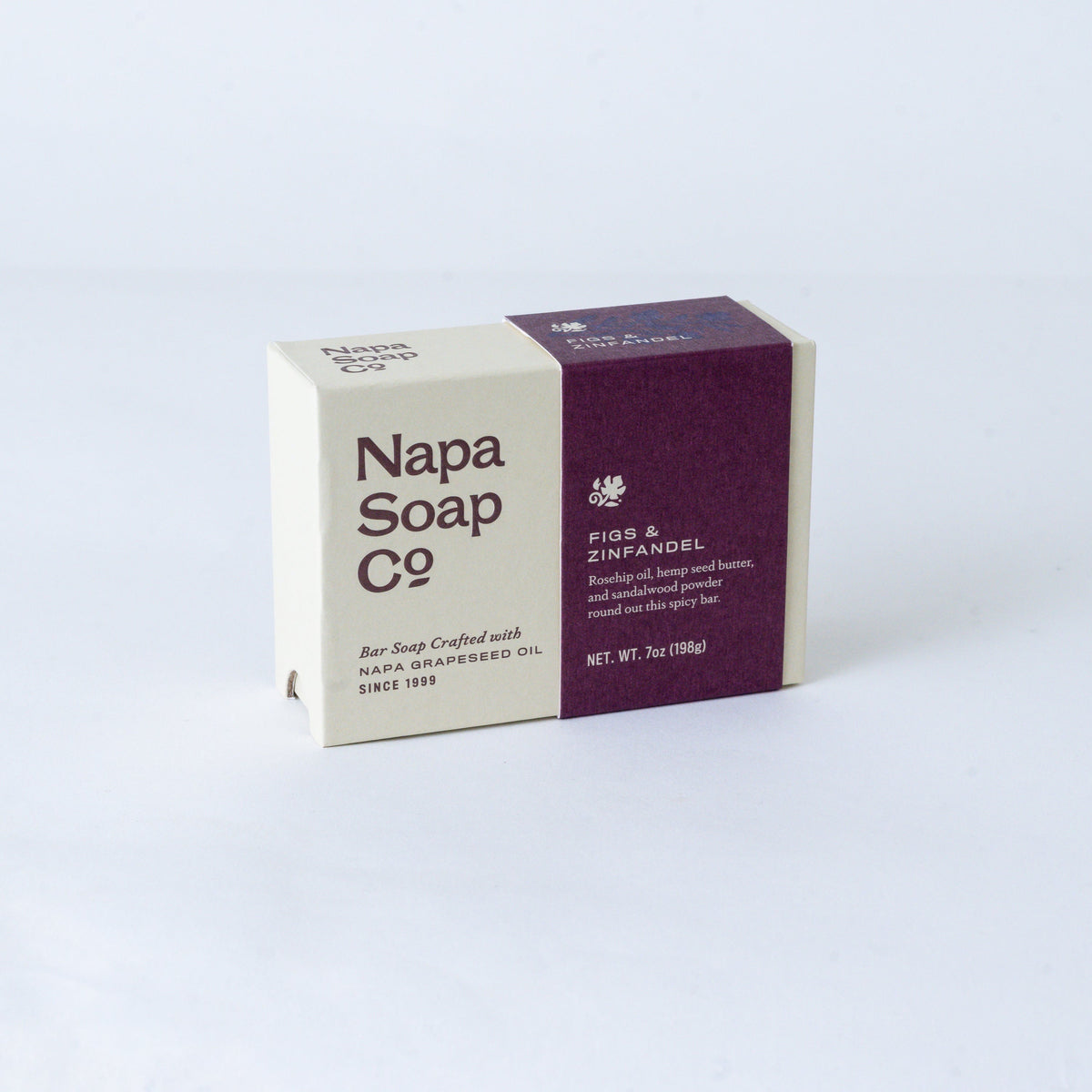Napa Soap Co. 'Figs & Zinfandel' bar soap in a rectangular box with a cream and deep purple color-blocked design, photographed on a light gray background.