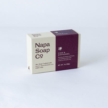 Napa Soap Co. 'Figs & Zinfandel' bar soap in a rectangular box with a cream and deep purple color-blocked design, photographed on a light gray background.