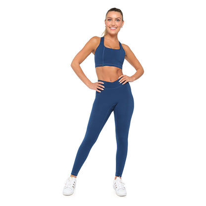 Woman wearing a blue athletic outfit on a white background
