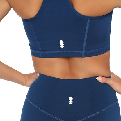 Navy blue sports bra and leggings set with a brand logo on a white background