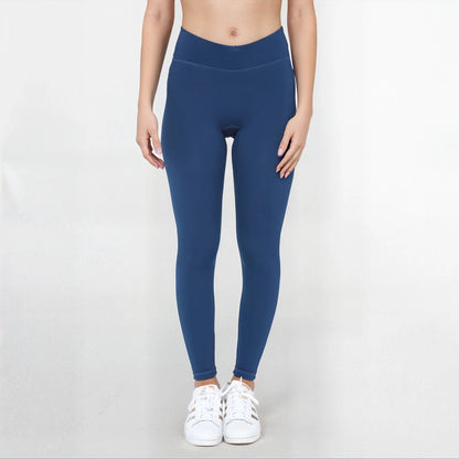 Person wearing blue leggings and white sneakers on a light gray background