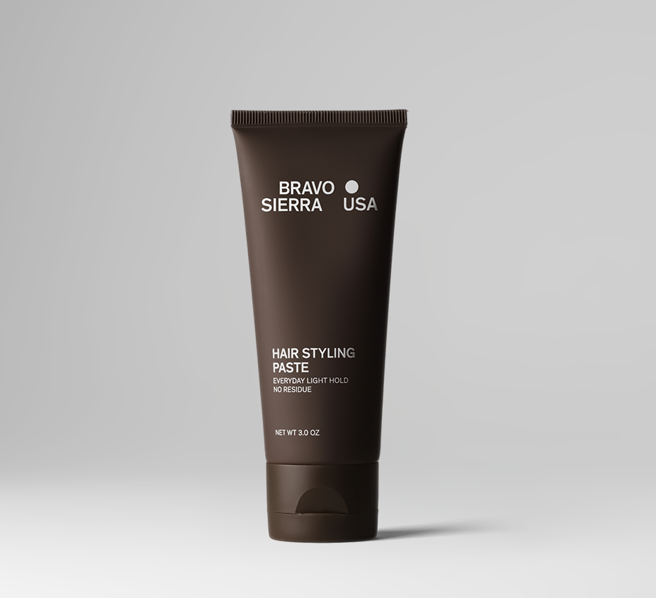 Brown tube of Bravo Sierra USA hair styling paste on a gray background