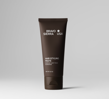 Brown tube of Bravo Sierra USA hair styling paste on a gray background