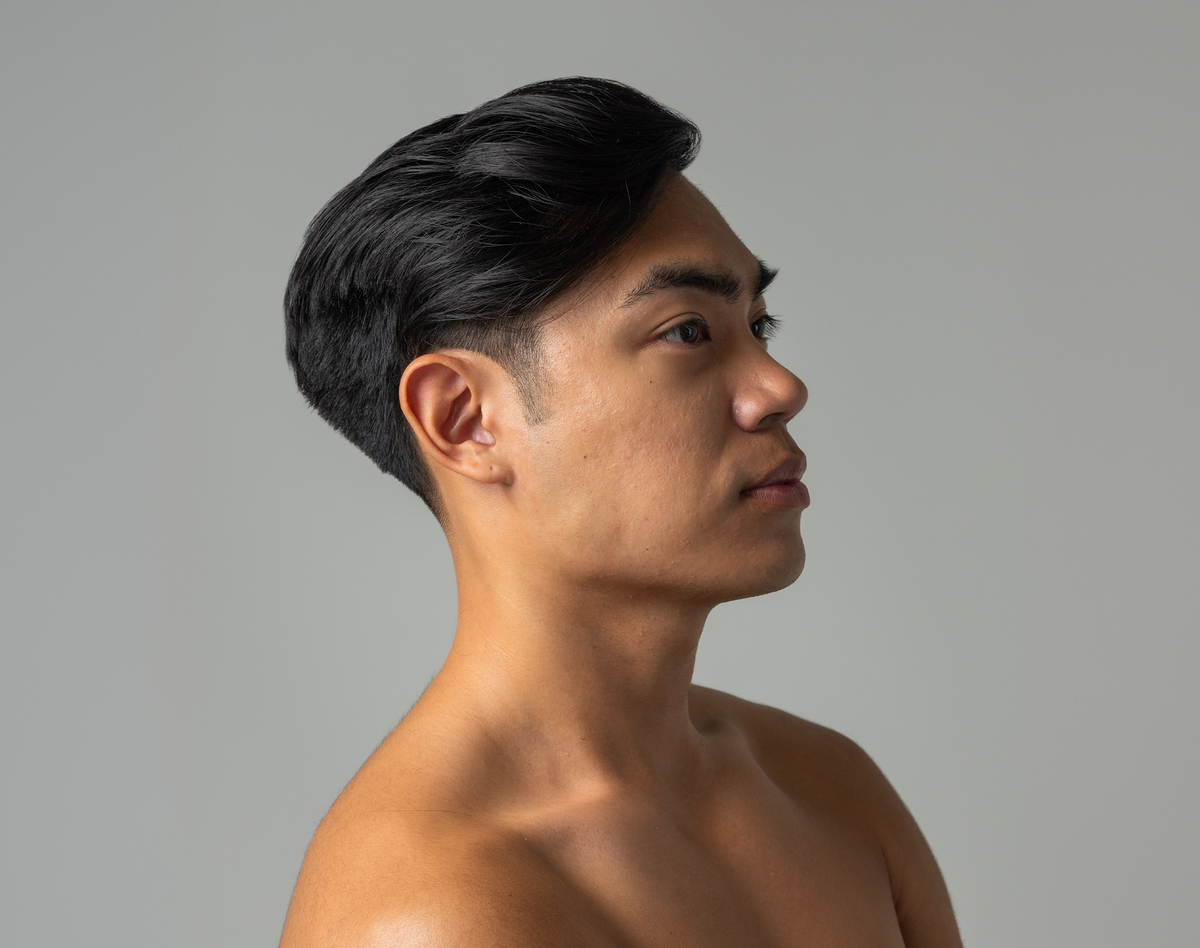 Man with styled hair against a plain background