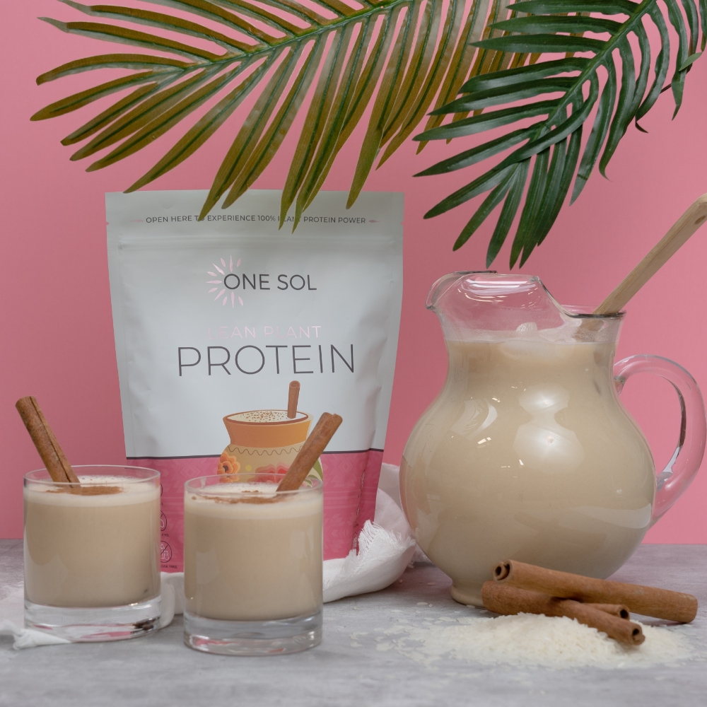 One Sol Protein package with a pitcher and glasses of protein shake on a pink background
