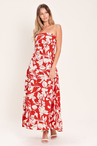 Woman wearing a red floral strapless dress on a white background