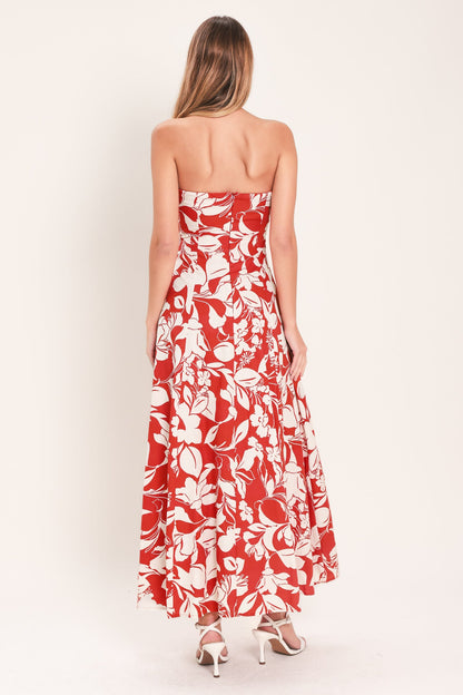 Woman wearing a strapless floral dress with a white background