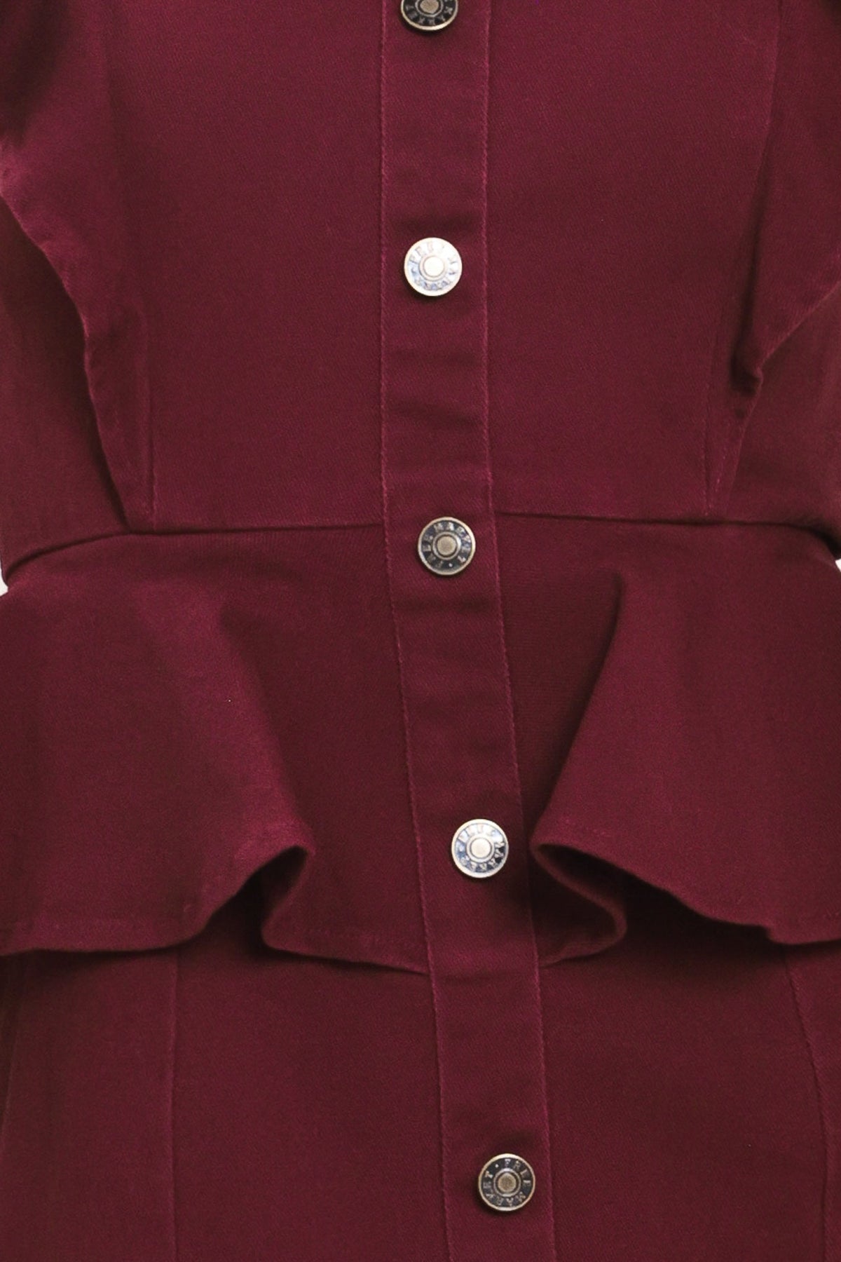 Close-up of a burgundy button-front garment with a peplum waist and decorative silver-tone buttons.