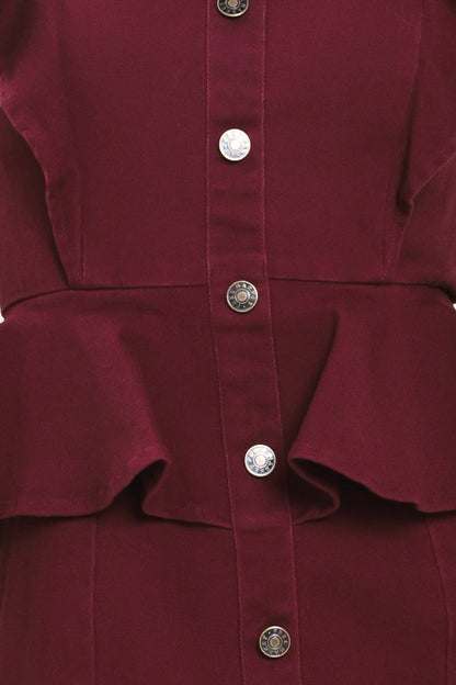 Close-up of a burgundy button-front garment with a peplum waist and decorative silver-tone buttons.