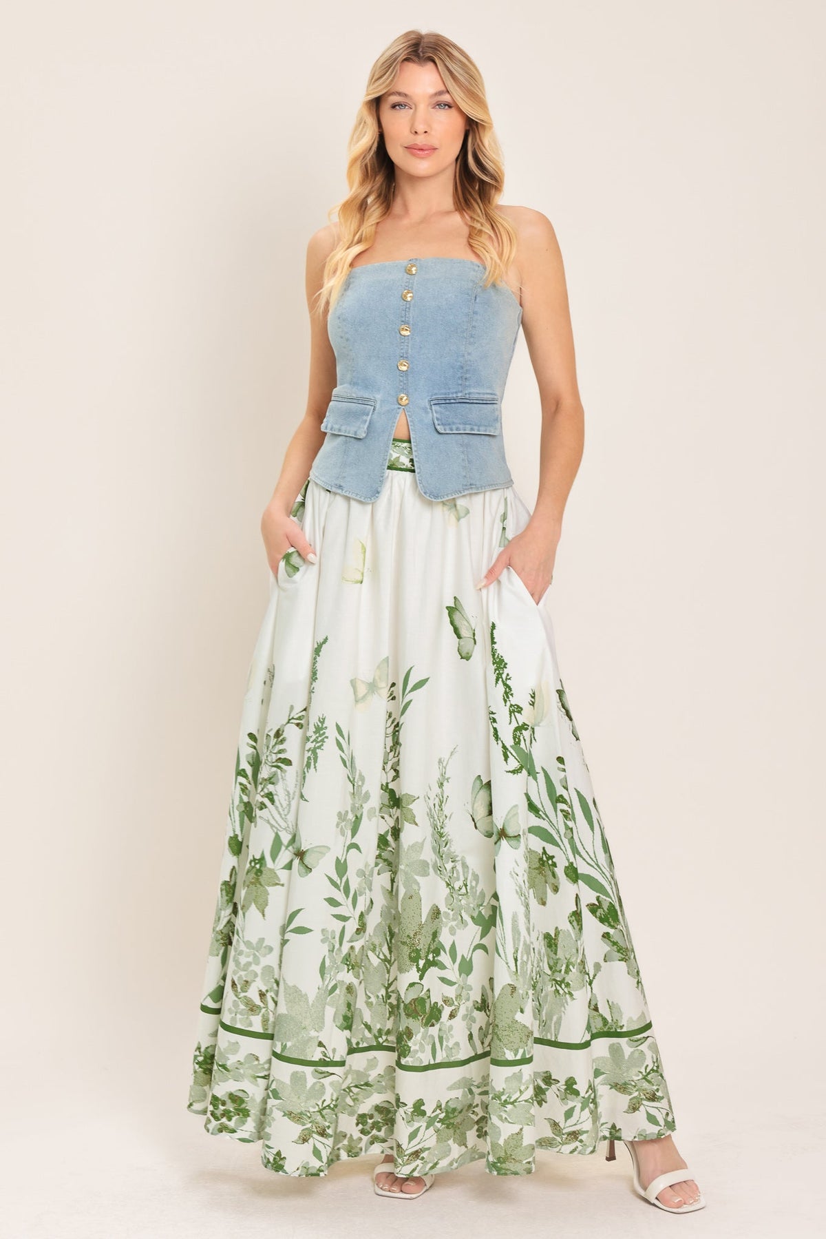 Model wearing the floral maxi skirt with the matching floral bustier top.