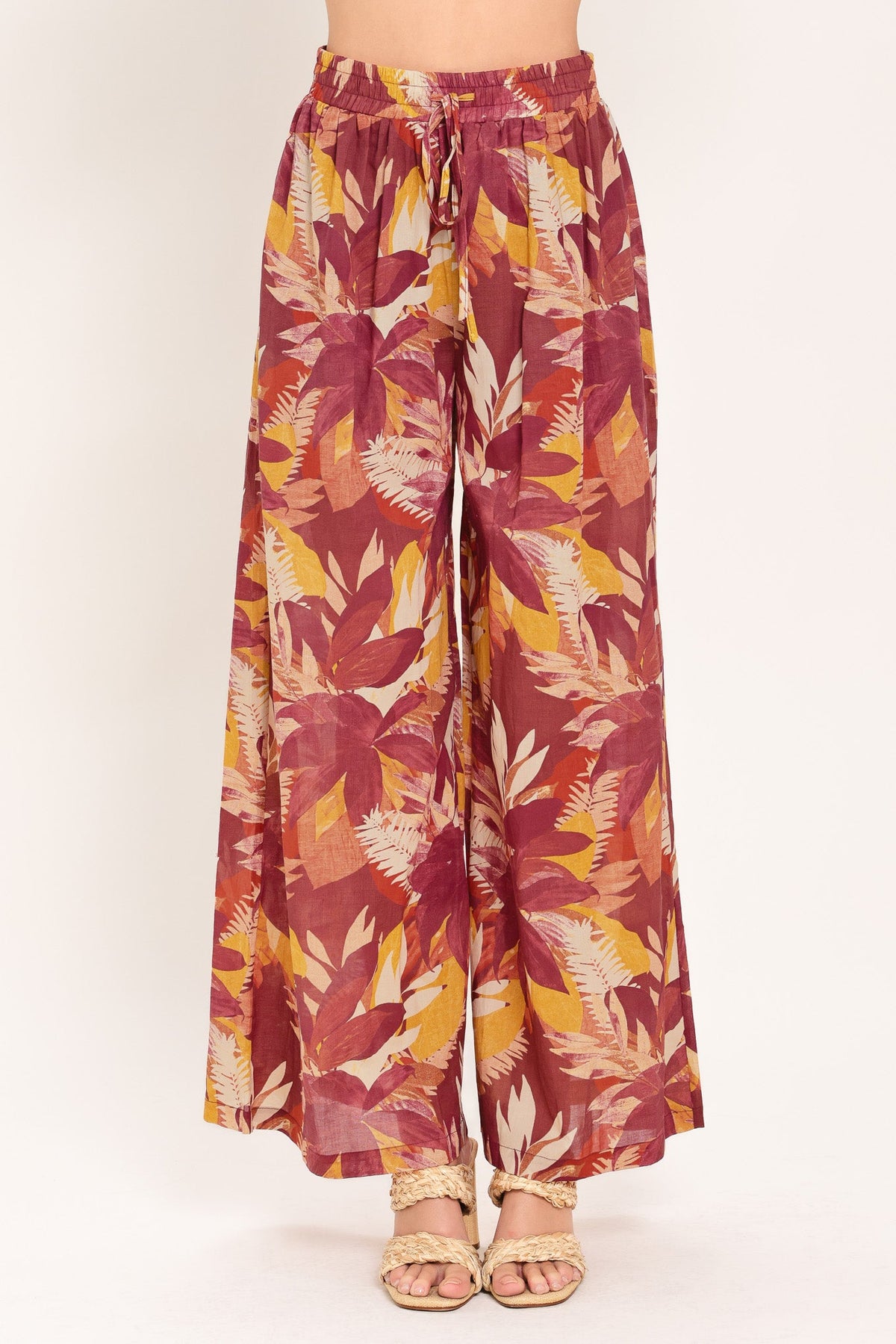 Burgundy floral print wide-leg palazzo pants shown on a model against a plain studio background.
