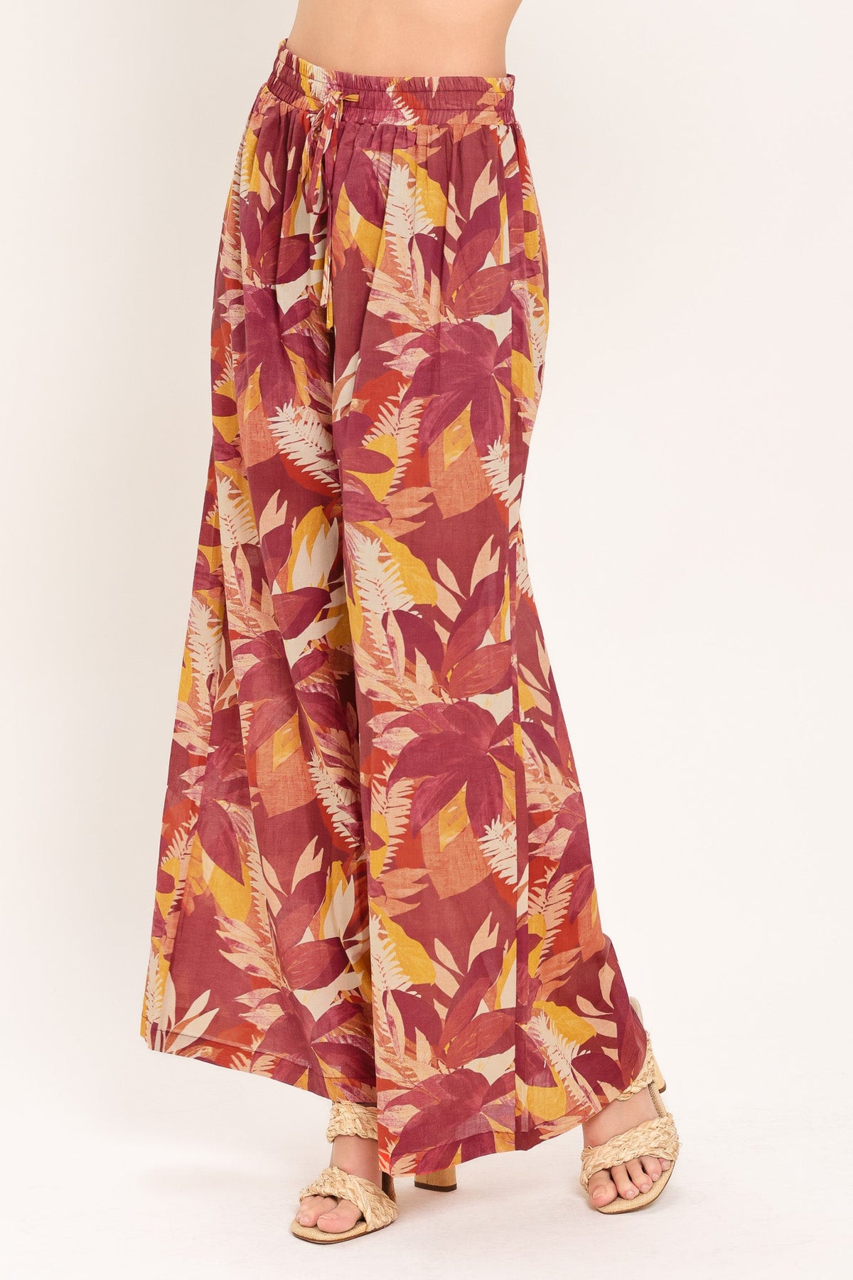 Close-up of the elastic waistband and adjustable tie on the burgundy floral palazzo pants.