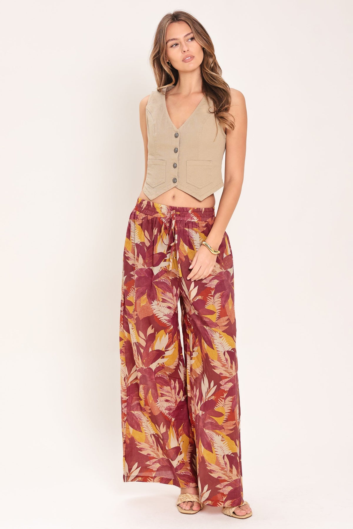 Burgundy floral print cotton palazzo pants worn on a model in a light studio setting.