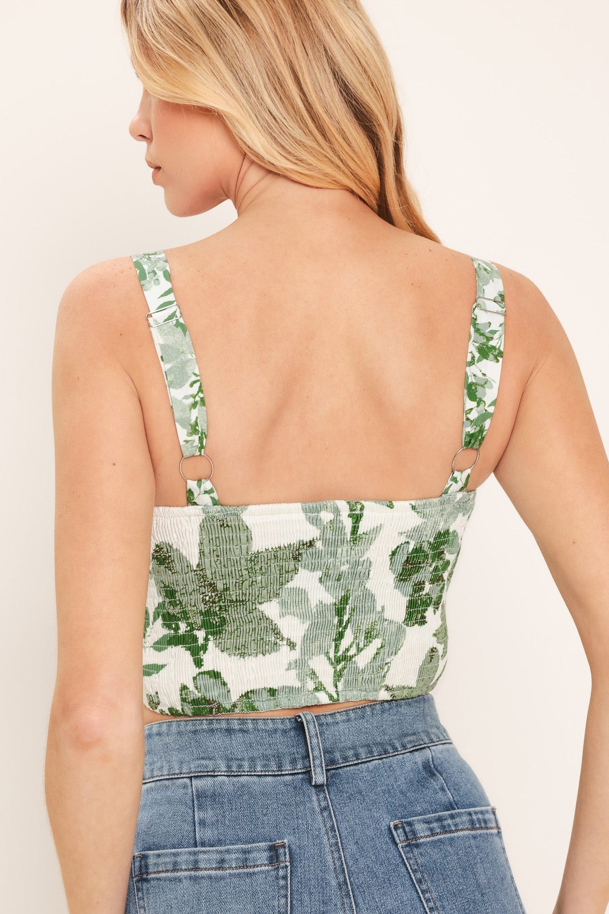 Model wearing the floral bustier top with the matching ivory and sage floral maxi skirt.