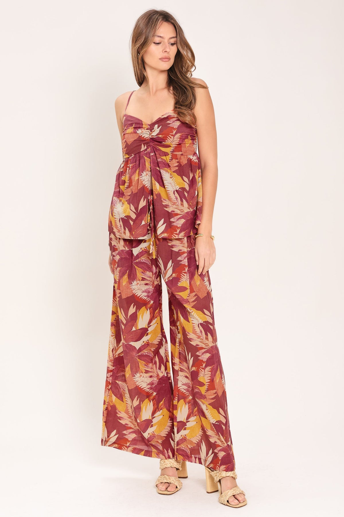 Front view of the burgundy printed top showing the split-front detail and gathered center.