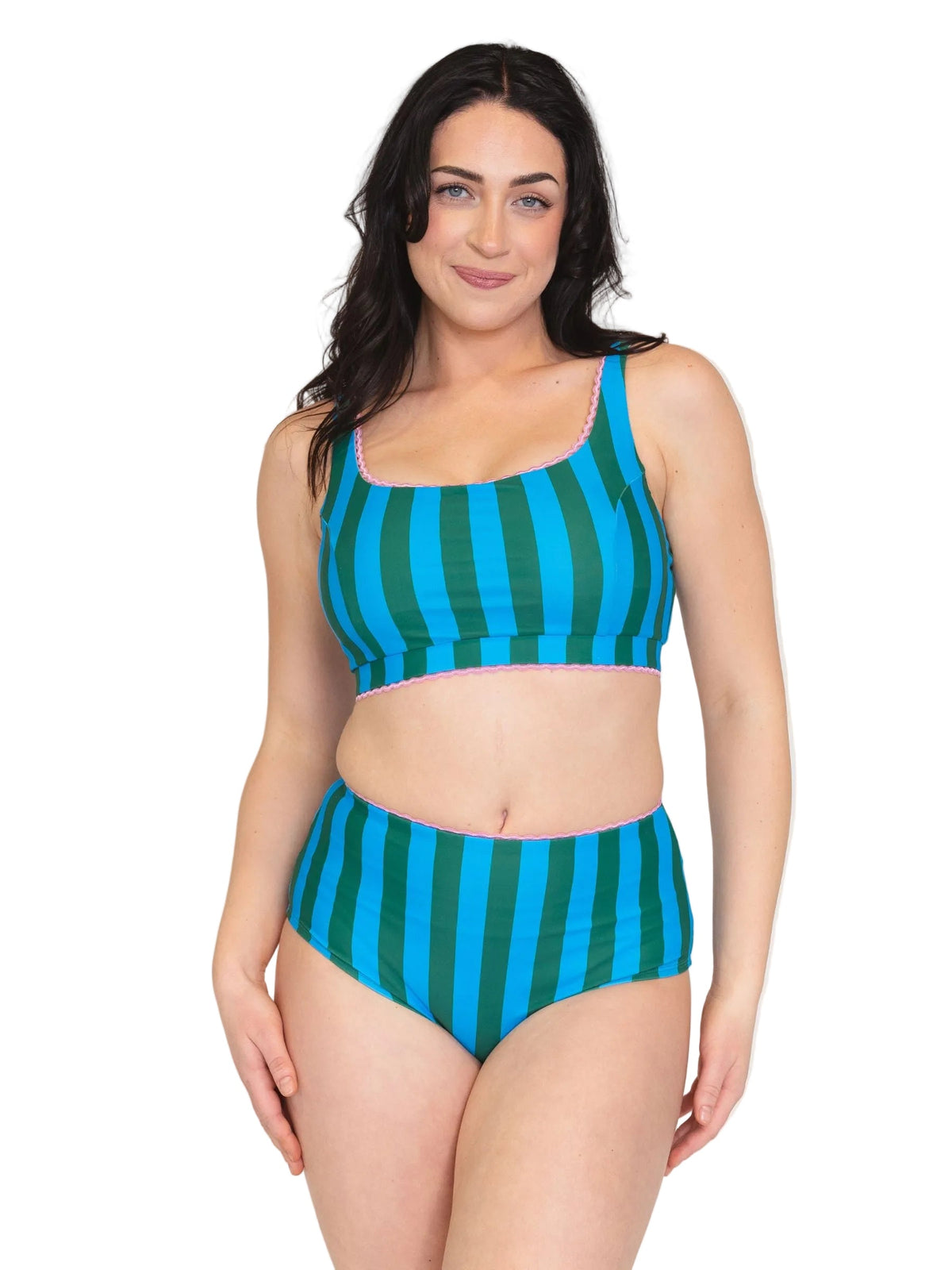 A woman modeling a two-piece bikini swimsuit with vertical teal and green stripes, featuring a scoop neck top and high-waisted bottoms, set against a plain white background.