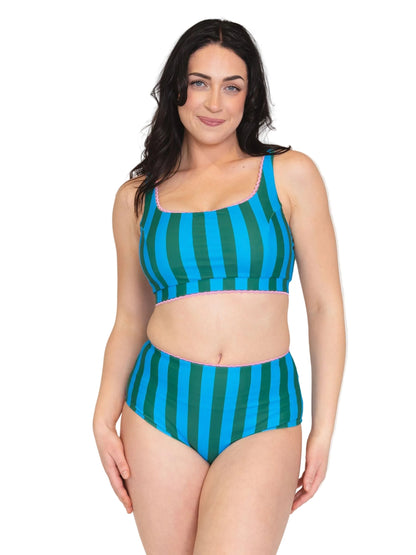 A woman modeling a two-piece bikini swimsuit with vertical teal and green stripes, featuring a scoop neck top and high-waisted bottoms, set against a plain white background.