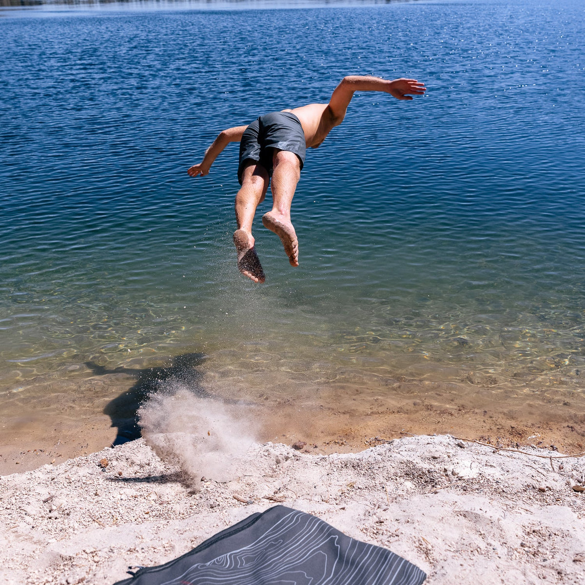 Laek Terrain Towel in Topo Black, rolled and packed down