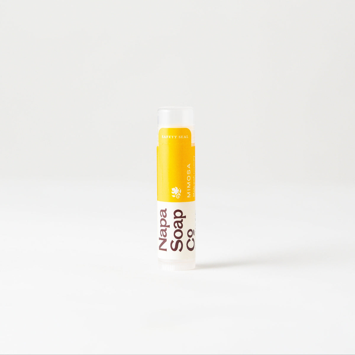 Mimosa Lip Balm by Napa Soap Company, yellow and white, on a white background