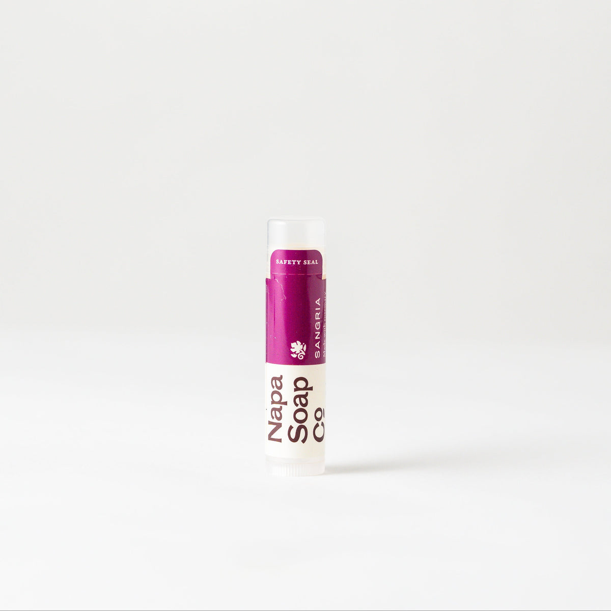 Sangria Lip Balm tube with a purple cap on a white background