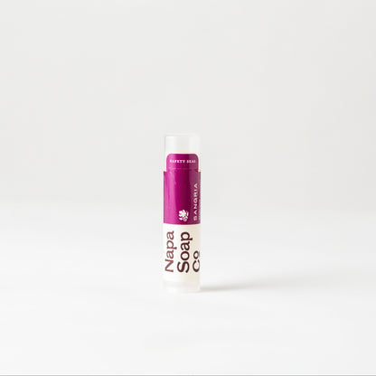 Sangria Lip Balm tube with a purple cap on a white background