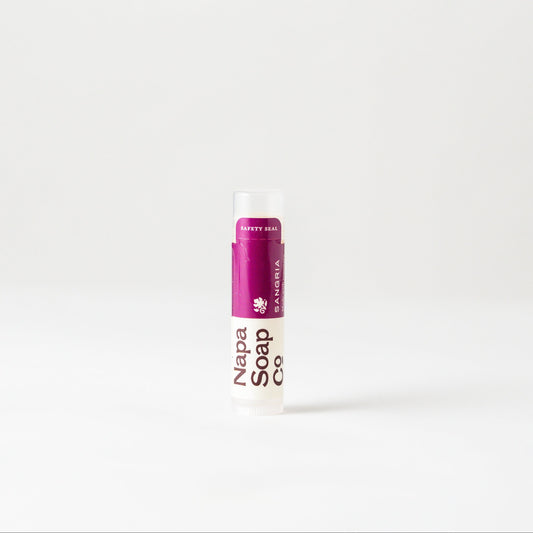 Sangria Lip Balm tube with a purple cap on a white background