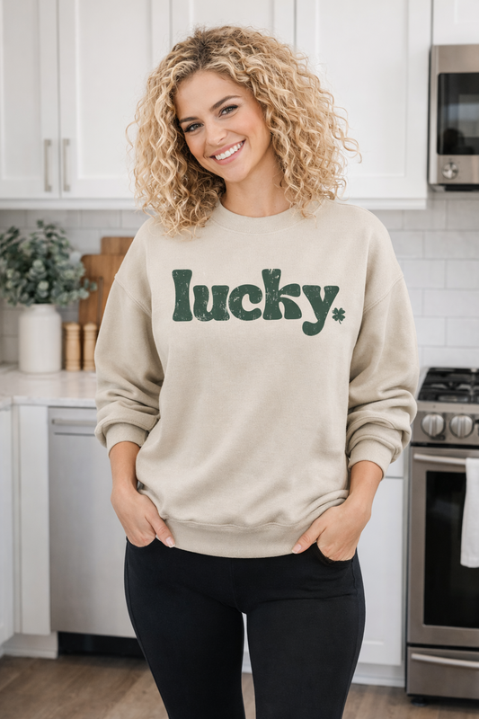 Fitkitty Culture Lucky Charm crewneck sweatshirt in sand, worn in a kitchen