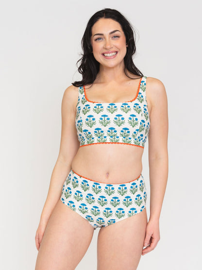 Woman wearing a floral bikini set on a white background