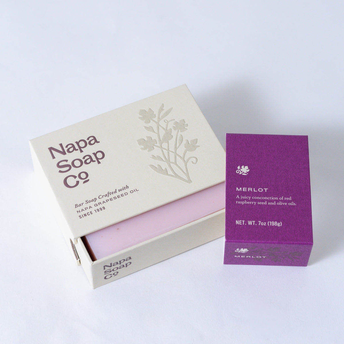 Napa Soap Co. soap bar in a box with a purple Merlot soap bar next to it on a white background