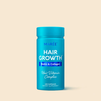 Blue bottle of Marée Hair Growth Biotin & Collagen supplement on a beige background
