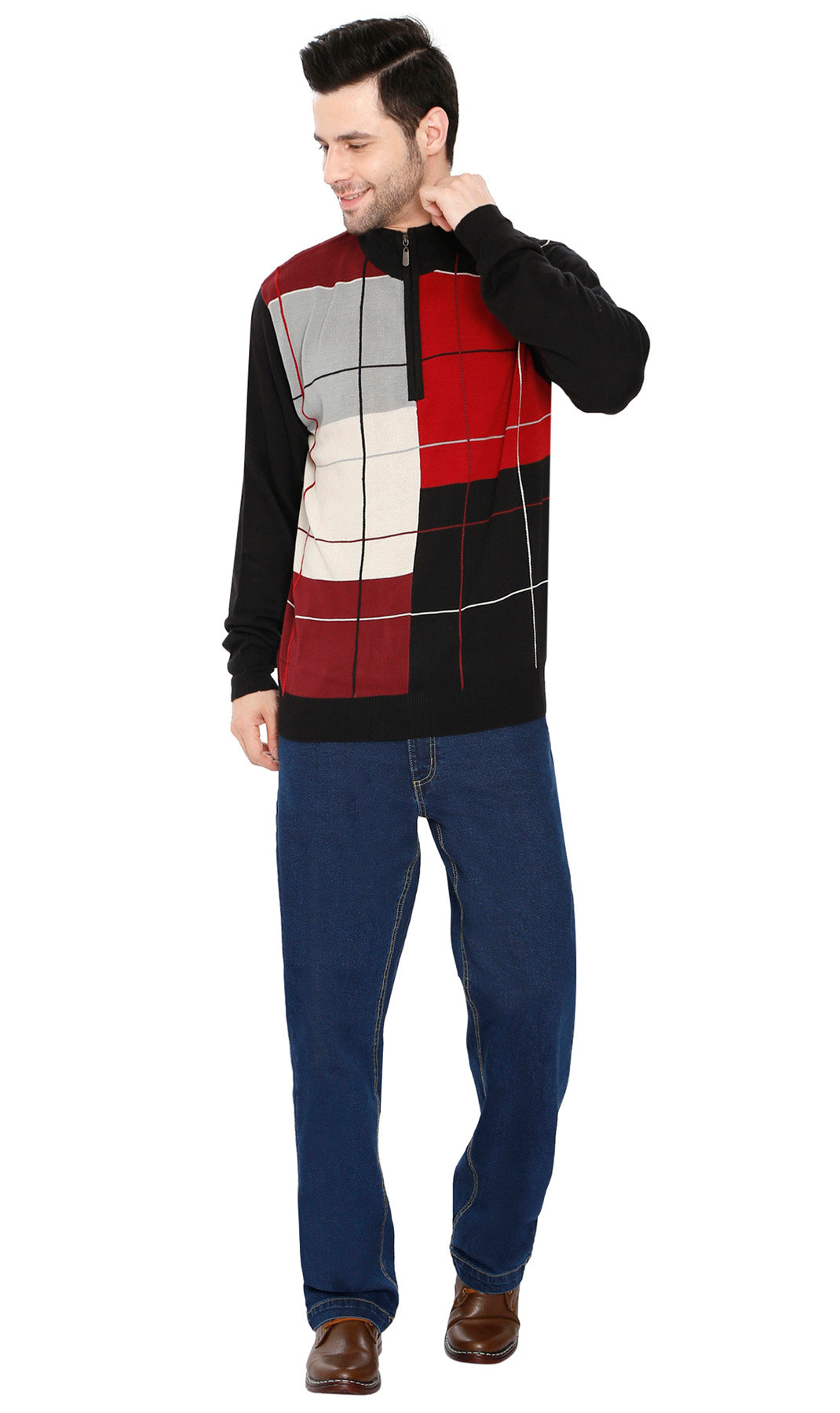 Man wearing a colorful checkered sweater and blue jeans on a white background