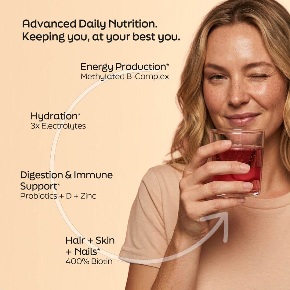Woman holding a glass of red liquid with nutritional benefits text on a beige background