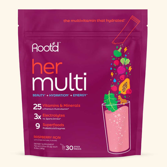 A stand-up pouch of Rootd Her Multi dietary supplement in Raspberry Acai flavor, featuring a deep magenta background with colorful fruit and a pink drink illustration, photographed on a light beige background.