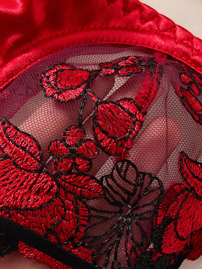 Close-up of red lace lingerie with floral embroidery